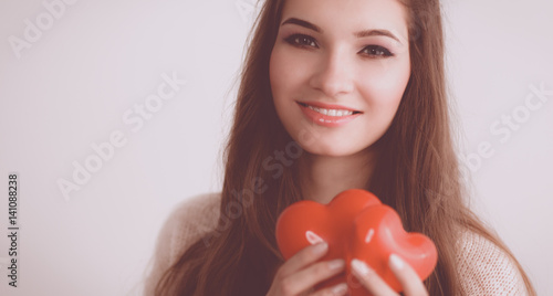 Portrait of beautiful happy woman holding a symbol heart.  © lenets_tan
