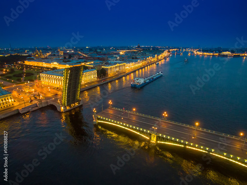 A divorced bridge with a floating ship. Neva River. Night city of St. Petersburg.