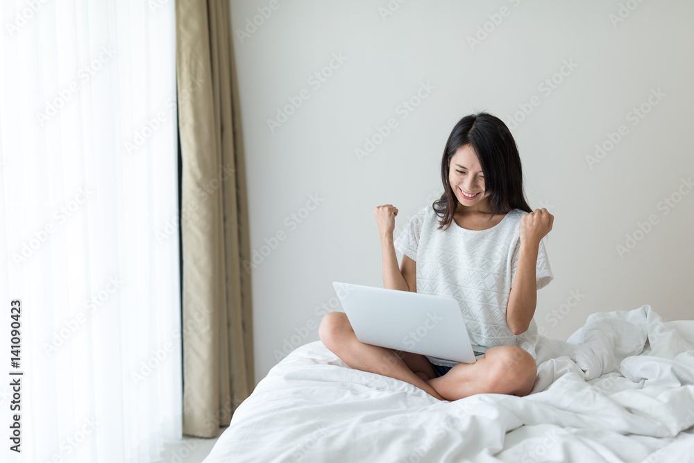 Thrilled woman working on notebook computer Thrilled woman working on notebook computer