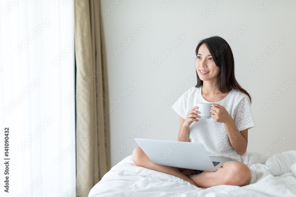 Woman working on notebook computer and enjoy her coffee Woman working on notebook computer and enjoy her coffee