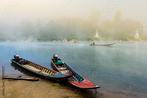 Moei(Thaungyin) River in the mist at sunrise,the natural border line between Thailand and Burma(Myanmar) with boat photo