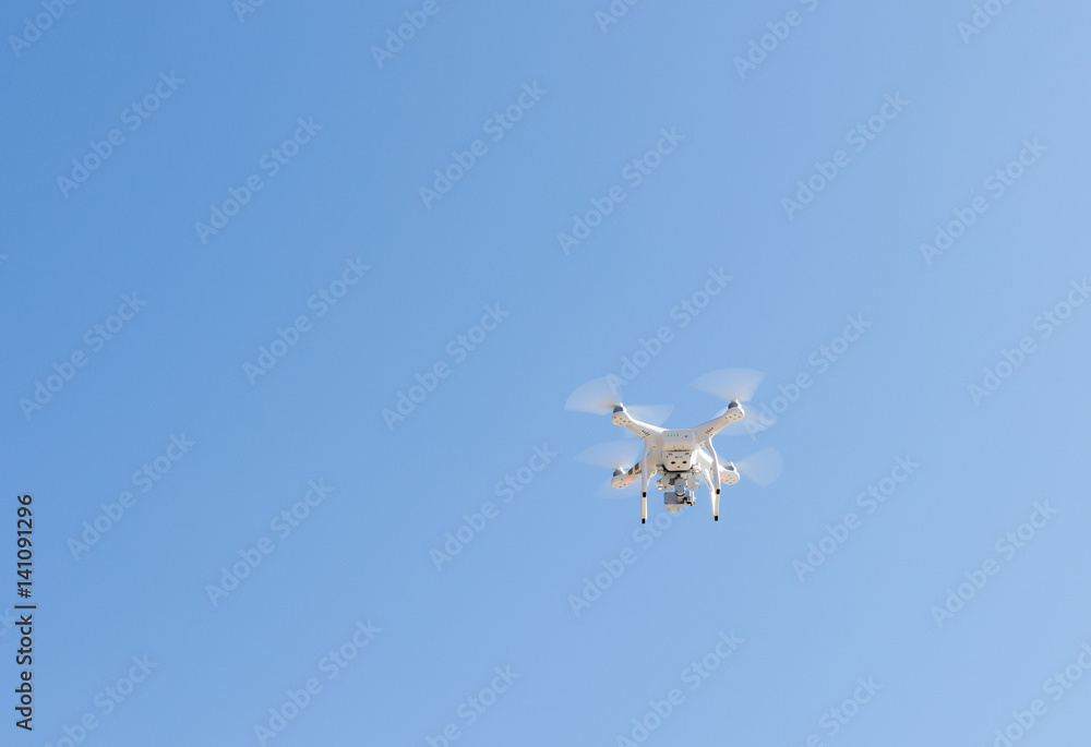 Fototapeta premium Modern Remote Control Air Drone Flying with action camera.