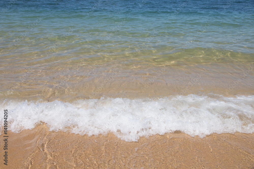 wave of blue sea on sandy beach. Background.