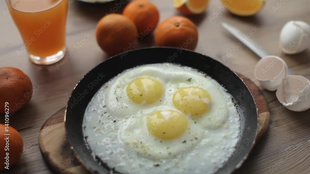 Breakfast Scrambled Eggs in a Frying Pan With Juice and Oranges Breakfast Scrambled Eggs in a Frying Pan With Juice and Oranges