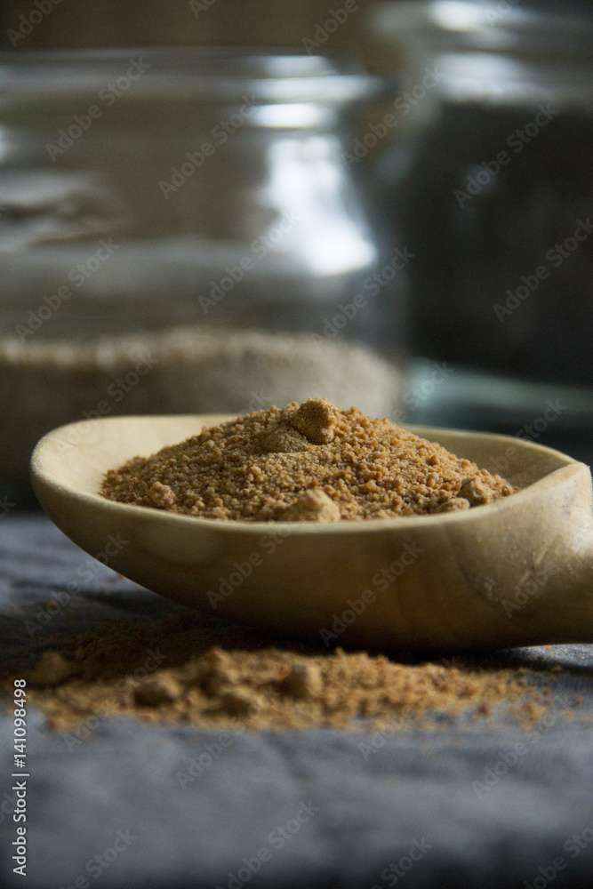 coconut blossom sugar on wooden spoon coconut blossom sugar on wooden spoon