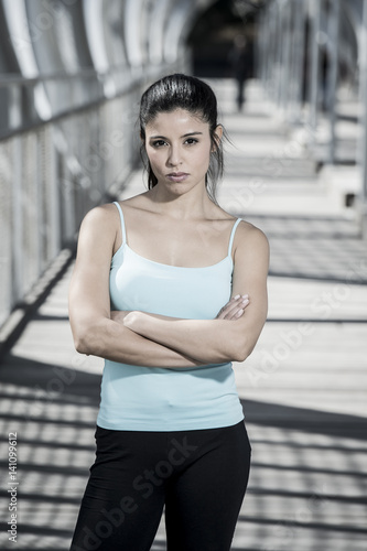 attractive hispanic brunette woman looking cool and defiant after running workout © Wordley Calvo Stock