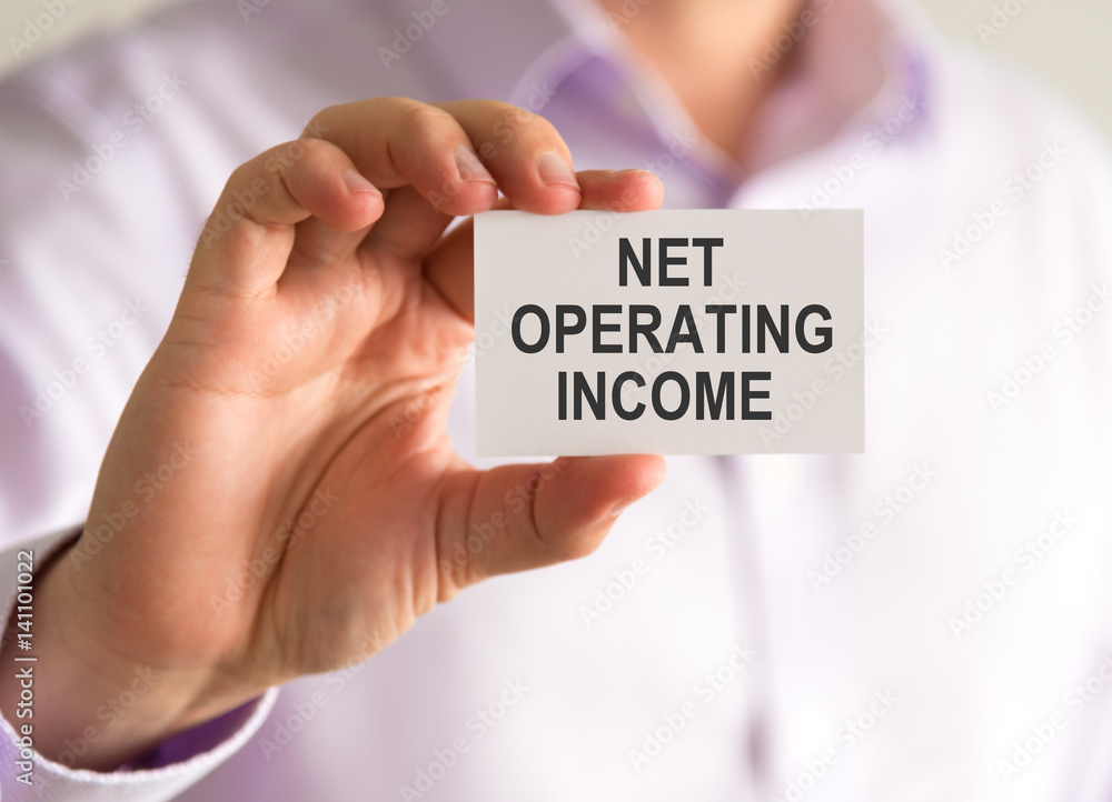 Businessman holding a card with NET OPERATING INCOME message Businessman holding a card with NET OPERATING INCOME message