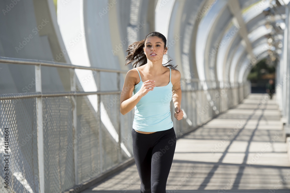 Fototapeta premium young beautiful athletic sport woman running and jogging crossing modern metal city bridge