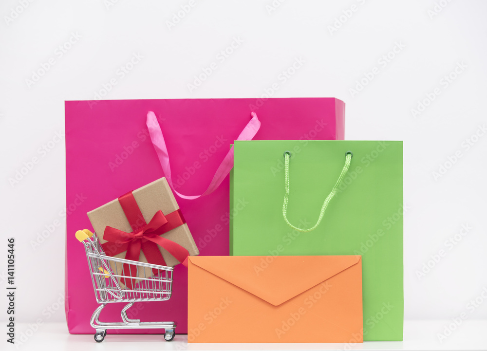 cool shopping bags, gift in shopping cart and envelope on the wonderful