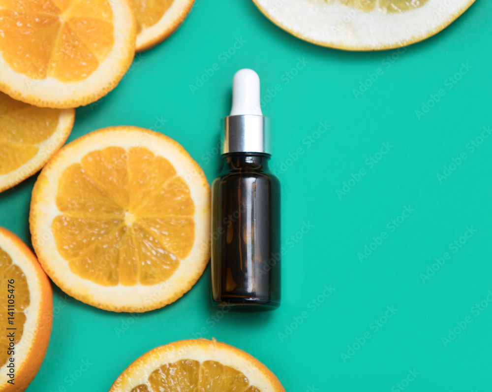 cute little serum near dried orange slices on the wonderful turquoise background cute little serum near dried orange slices on the wonderful turquoise background