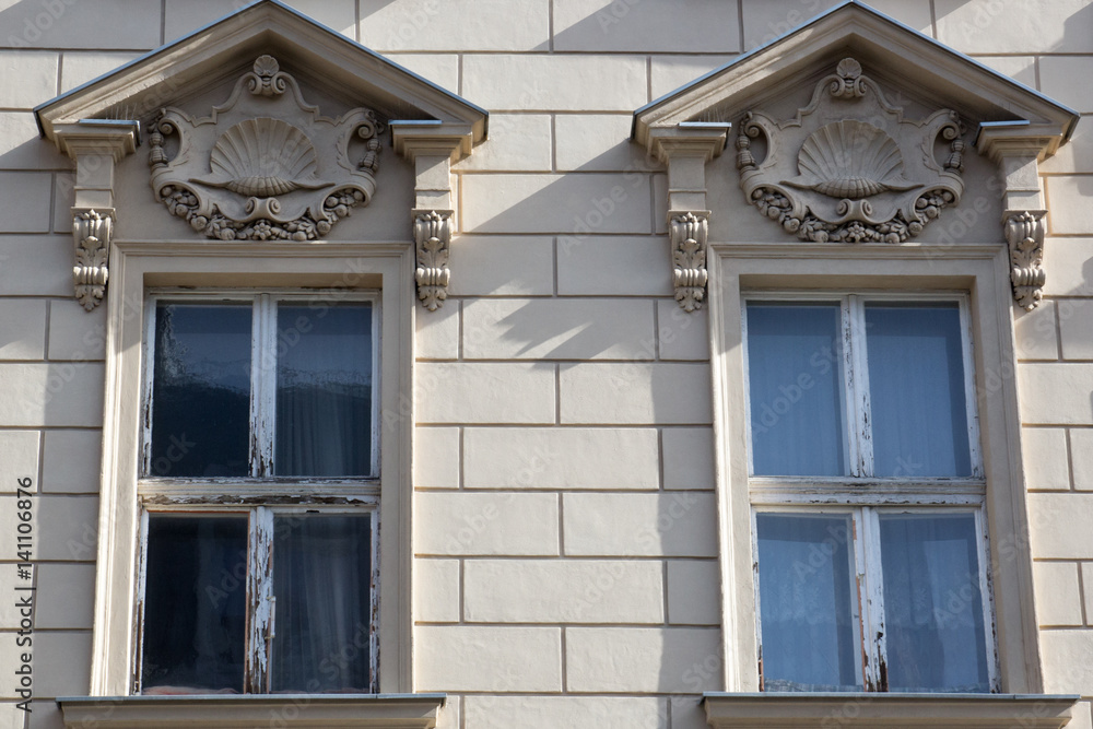 Fototapeta premium Two vintage front glass windows of an old house