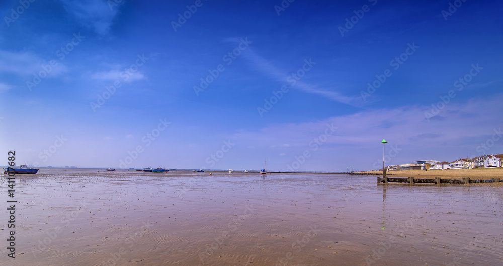 13th May 2016 - Low tide at Thorpe Bay near Southend on Sea Essex. Fishing boats can be seen resting on their sides. Sky is blue and it is nice and sunny.