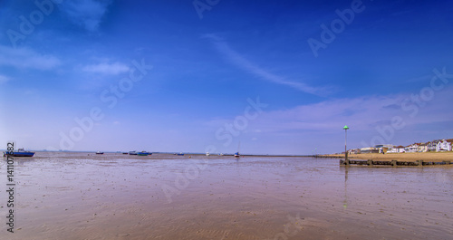 13th May 2016 - Low tide at Thorpe Bay near Southend on Sea Essex. Fishing boats can be seen resting on their sides. Sky is blue and it is nice and sunny.