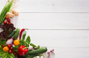 Fresh vegetables border on white wood background with copy space