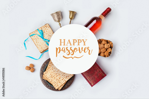 Jewish holiday Passover banner design with wine, matza and seder plate on white background. View from above. Flat lay