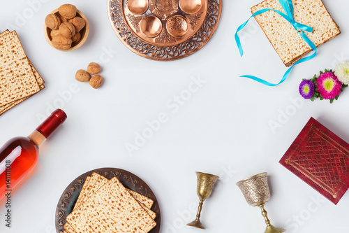 Jewish holiday Passover background with wine, matza and seder plate. View from above. Flat lay