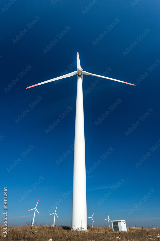Wind turbines against a blue sky generating electricity Wind turbines against a blue sky generating electricity
