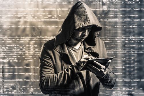 Internet crime concept. Dangerous hacker, in hoodie shirt and dark digital background around, stealing your data.
