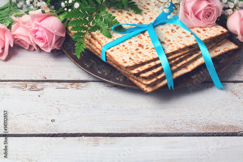Fototapeta Jewish holiday Passover Pesah background with  matzoh and rose flowers