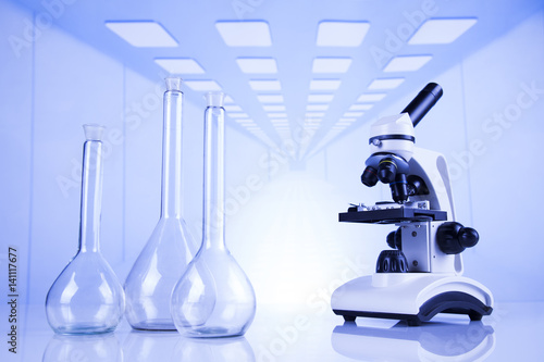 Laboratory work place with microscope and glassware