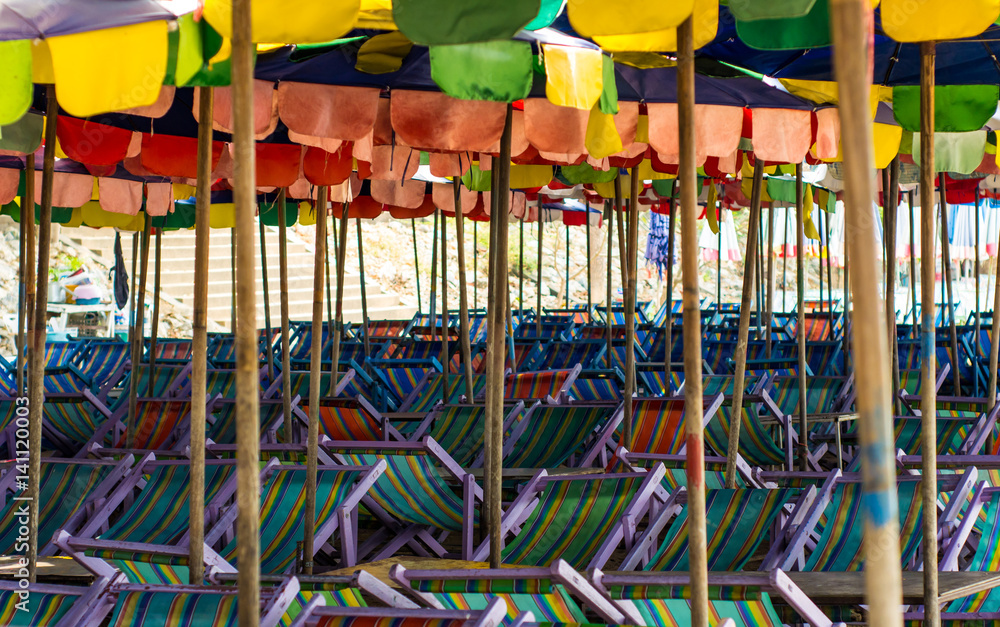 Old umbrella and chairs on beach