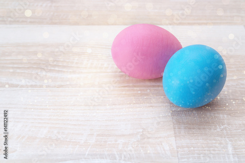 Colored Easter eggs on wooden background.