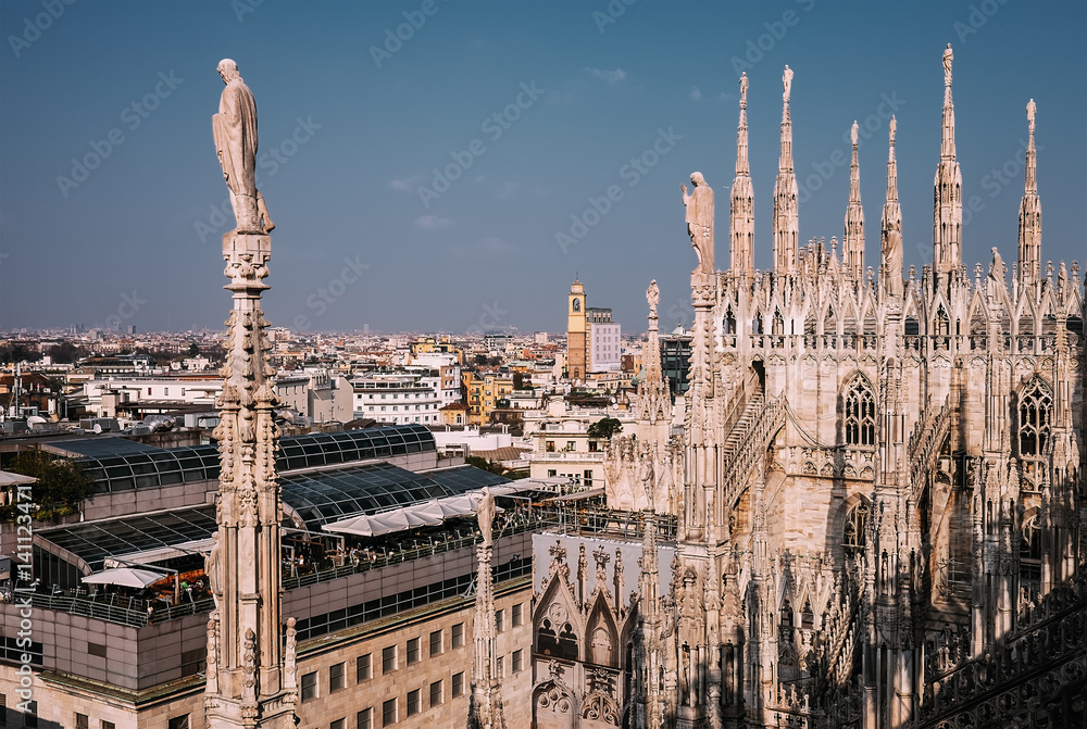 Numerous steeples with statues on Duomo di Milano main Cathedral