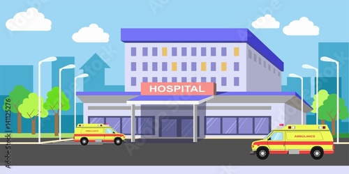 Urban hospital building exterior with ambulances on yard