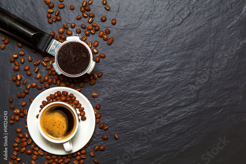 Coffee background - top view. Coffee in a holder and coffee beans photo