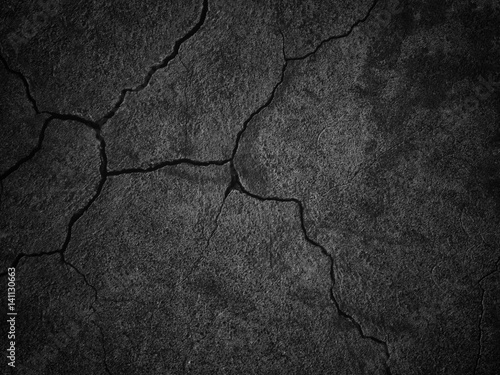 black wall with cracks text...