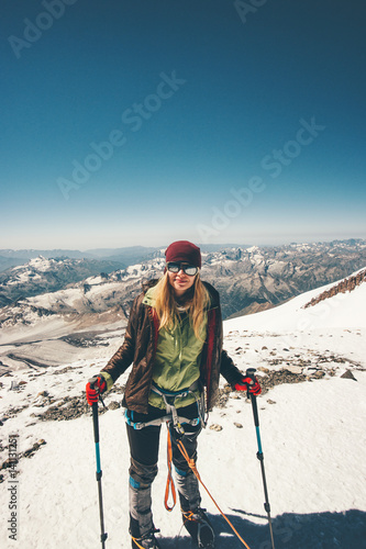 Woman climber on mountain summit Travel Lifestyle success concept adventure active vacations outdoor happy emotions enjoying peaks landscape
