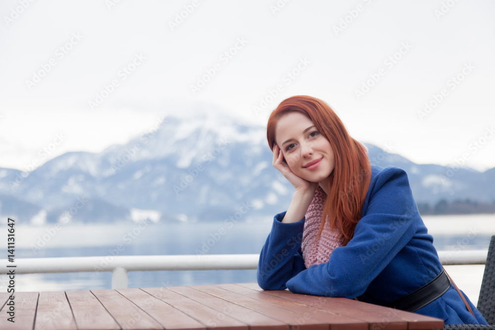 beautiful young woman sitting near table on the mountains background beautiful young woman sitting near table on the mountains background