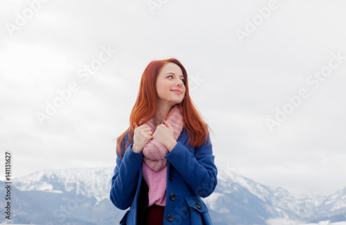 beautiful young woman on the mountains background