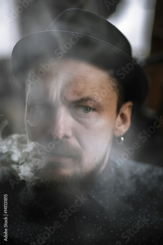 Man portrait smoking an electronic cigarette