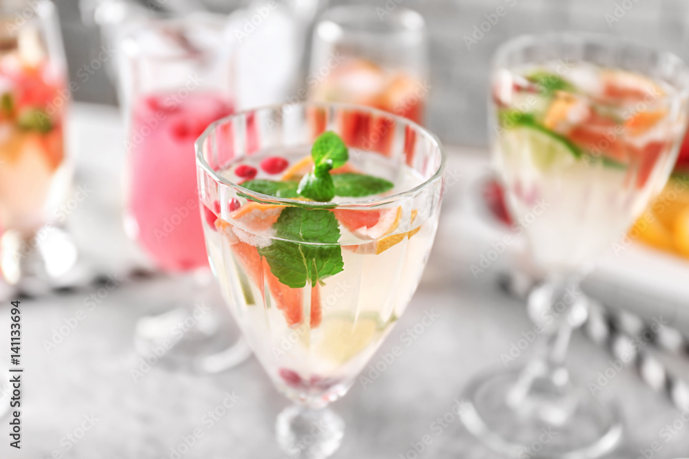 Glass of delicious wine spritzer on grey table Glass of delicious wine spritzer on grey table