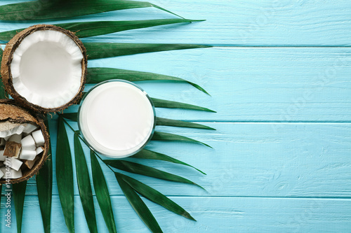 Composition with fresh coconut milk on wooden background photo