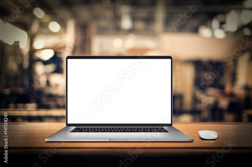 Laptop with blank screen on table.