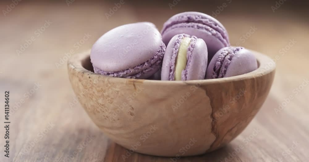 lavender violet macarons in wood bowl back slide reveal on table, 4k prores footage lavender violet macarons in wood bowl back slide reveal on table, 4k prores footage