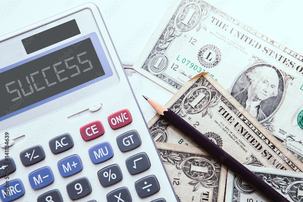 Calculator with american dollars on the wooden table background, finance concept Calculator with american dollars on the wooden table background, finance concept