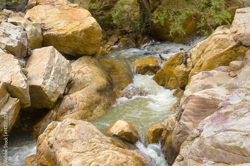 Swartberg Pass in South Africa.  A stream tumbles though a rocky pool photo