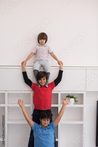 Fototapeta Naklejka Na Ścianę i Meble -  young boys posing line up piggyback