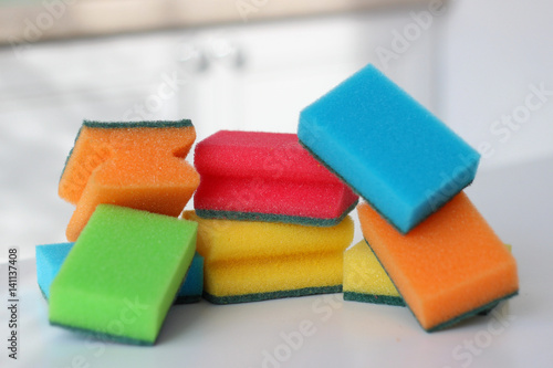 Multi-colored sponges on the kitchen table