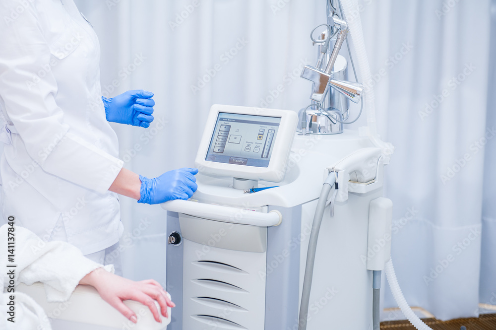 Skin Treatment Laser Equipment. Medical Worker Sets Indices On Screen Of  Laser for cosmetic procedures. Close up Beautician Using Beauty Machine In  Cosmetology Center, Beauty Salon. Selective focus Stock Photo | Adobe