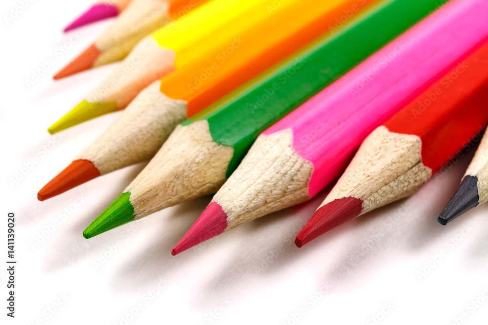 Wooden color pencils on a white background, view at an angle Wooden color pencils on a white background, view at an angle