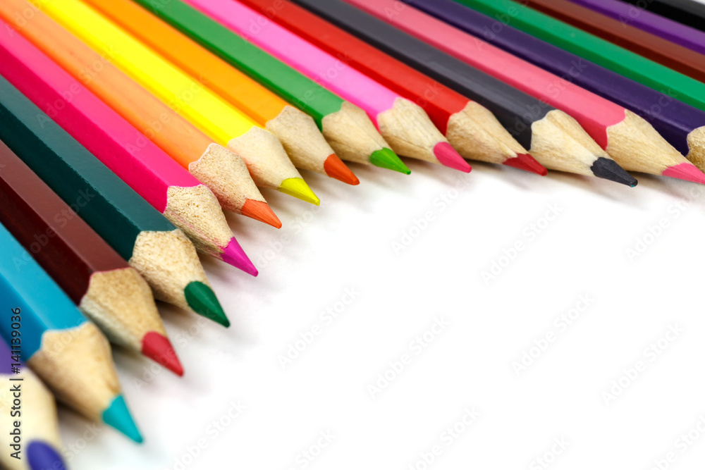 Wooden color pencils on a white background, view at an angle Wooden color pencils on a white background, view at an angle