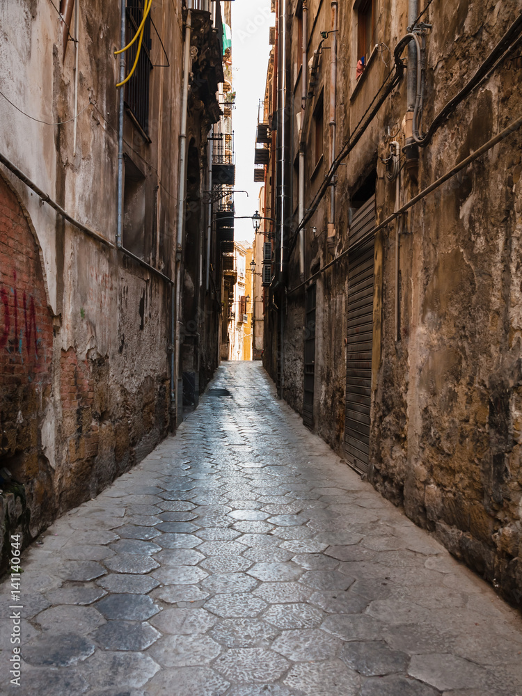 narrow street with stone pavement in Palermo