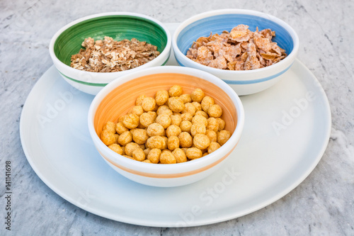 three kind of cold breakfast cereals in bowl