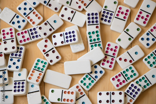 Colorful Dominoes Spread Out on Wooden Floor
