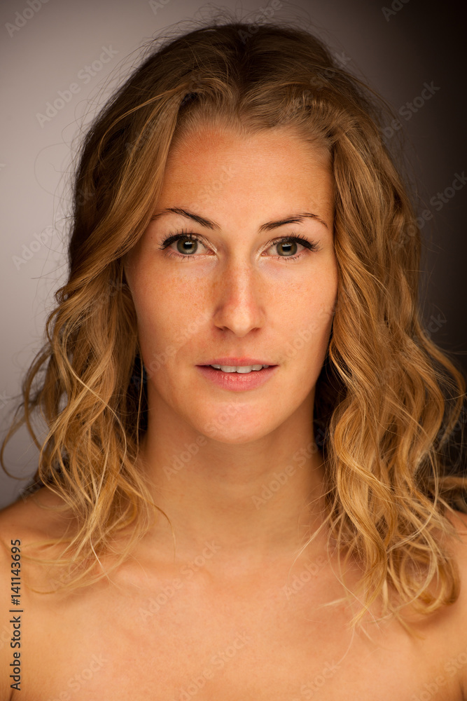 Beauty portrait of a cute brunette woman with curly hair over black background Beauty portrait of a cute brunette woman with curly hair over black background
