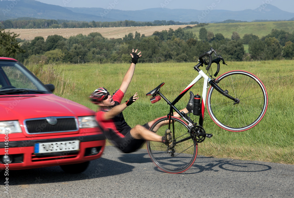 Obraz premium Accident cars with biker. Car collides cyclist on the road. Dangerous traffic on asphalt way on the countryside. Road crash misfortune car with a cyclist. Careless driving.